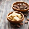 Natural cocoa butter and cocoa beans on a old wooden background