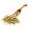 Dried Sweetgrass Hierochloe on the wooden spoon. Macro photo.